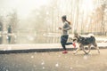 Image of young girl running with her dog, alaskan malamute Royalty Free Stock Photo