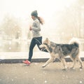 Image of young girl running with her dog, alaskan malamute Royalty Free Stock Photo