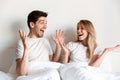 Happy excited loving couple lies in bed looking at each other Royalty Free Stock Photo