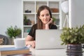 Image of young happy white business woman sitting at office desk, working from home, using laptop computer, having video chat Royalty Free Stock Photo