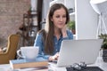 Image of young happy white business woman sitting at office desk, working from home, using laptop computer, having video chat Royalty Free Stock Photo