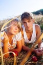 Image of young man and woman with apples on wheat field Royalty Free Stock Photo