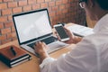 Image of Young man working in front of the laptop looking at screen with a clean white screen and blank space for text, hand Royalty Free Stock Photo