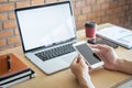 Image of Young man working in front of the laptop looking at screen with a clean white screen and blank space for text, hand Royalty Free Stock Photo