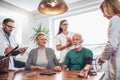 Young medic taking blood pressure during home visit Royalty Free Stock Photo