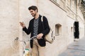 Smiling business man using mobile phone on a bicycle Royalty Free Stock Photo