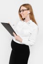 Image of a young pregnant business woman with glasses, pensive girl holds a folder with documents in hand and writes reports Royalty Free Stock Photo