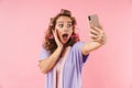 Image of young surprised woman taking selfie on cellphone Royalty Free Stock Photo