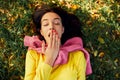 Image of young teenage girl yawing and relaxing outside in nature green park. Asleep young beautiful woman lying outdoors on green Royalty Free Stock Photo