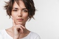 Beautiful young pretty thinking thoughtful woman posing isolated over white wall background