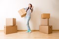 Image of young woman among cardboard boxes Royalty Free Stock Photo