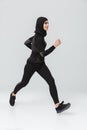 Woman fitness muslim posing running jumping isolated over white wall background Royalty Free Stock Photo