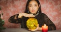 The image of a young woman is a fortune teller, a horoscope, a life in a magical crystal ball, and a gypsy card in the beliefs of Royalty Free Stock Photo