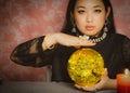 The image of a young woman is a fortune teller, a horoscope, a life in a magical crystal ball, and a gypsy card in the beliefs of Royalty Free Stock Photo