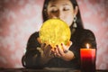 The image of a young woman is a fortune teller, a horoscope, a life in a magical crystal ball, and a gypsy card in the beliefs of Royalty Free Stock Photo