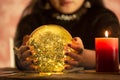 The image of a young woman is a fortune teller, a horoscope, a life in a magical crystal ball, and a gypsy card in the beliefs of Royalty Free Stock Photo