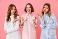 Image of young women 20s with brown hair wearing leisure clothings having fun with sweet desserts donuts at slumber Royalty Free Stock Photo