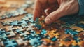 Person\'s hand strategically inserting a multicolored puzzle piece into jigsaw puzzle