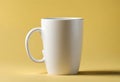 Blank coffee cup on the table. Isolated on yellow background, v17 Royalty Free Stock Photo