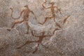 Images of ancient people from ocher on the wall of the cave.