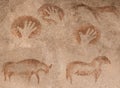 Images in a cave of prehistoric animals and hand-made