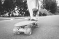 Images of a leg standing on a skateboard. Sunny evening in the park. Skateboarding concept