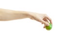 Men`s hand puts down a whole lime isolated on white background. Hand lowers down lime