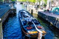 Amsterdam Canals and people enjoying spare on their boats on a sunny day Royalty Free Stock Photo