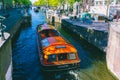 Amsterdam Canals and people enjoying spare on their boats on a sunny day Royalty Free Stock Photo