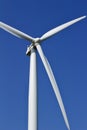 Close up view of the propellers on a giant wind power turbine with blue sky background