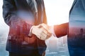 ImageStock Double exposure of business agreement handshake with city building landscape background Royalty Free Stock Photo