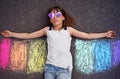 Imaginary creative play. A child plays with sidewalk chalk rainbow wings Royalty Free Stock Photo