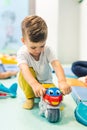 Imagination and creative thinking development. Language and social skills. Toddler playing with colorful plastic toys