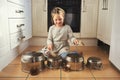 Imagination is her favourite toy. a little girl playing drums on a set of pots in the kitchen. Royalty Free Stock Photo