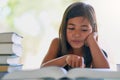 Imagination travels through reading. a little girl reading a book at home. Royalty Free Stock Photo