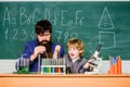 Imagination at Work. father and son at school. bearded man teacher with little boy. Back to school. Explaining biology