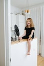 Imaginative little girl smiling at the mirror with her missing teeth