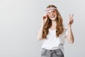Imagine all people living life in peace. Portrait of carefree stylish young woman in headband and trendy sunglasses