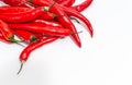 Close up of bunch of long red chili peppers on a white background isolated. It lies diagonally