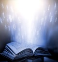 Imagine opening an old book blurred with magic power, with English letters floating on the light. Royalty Free Stock Photo