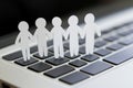 Imagine paper humans standing in a circle on a computer keyboard