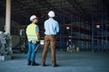 Imagine what we could do with all of that space. two builders inspecting a construction site.