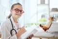Imagine yourself being who you dream of being. a little girl pretending to be a doctor while examining her stuffed Royalty Free Stock Photo