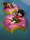 Adorable BJD Ball Joint Doll branded LATI in swimming suit. They`re ready to play water with colorful pool floats.