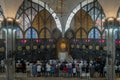 The Imam is the leader of the prayer, Religious muslim men praying for God on the floor in the Central Mosque and Islamic Center