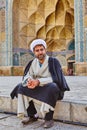Imam sits in courtyard of Jame Mosque, Isfahan, Iran.