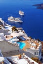 Imerovigli village architecture overlooking the cruise ships in the caldera, Santorini island