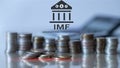 IMF. International Monetary Fund. Finance and banking concept. Coins background