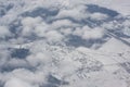 Snow city in clouds. Airplane top view