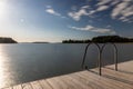 A swimming jetty during a golden sunset over the Turku Archipelago near the village of Naantali Royalty Free Stock Photo